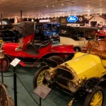 Historic automobiles displayed inside a transportation museum