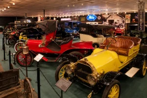 Historic automobiles displayed inside a transportation museum