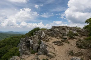 Rocky Shenandoah mountain summit beneath a partly cloudy sky