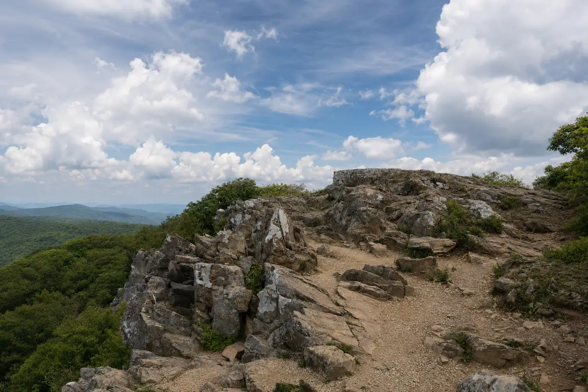 Rocky Shenandoah mountain summit beneath a partly cloudy sky