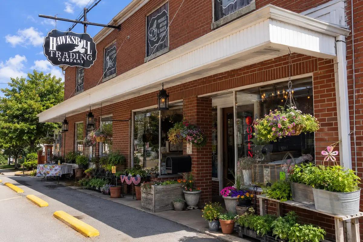 Hawksbill Trading Company storefront with plants and hanging flowers