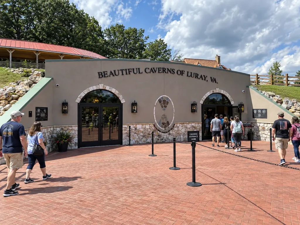 Visitors walking toward the entrance of Luray Caverns on a sunny day
